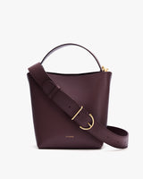 Bucket bag with wide strap and gold buckle detail.