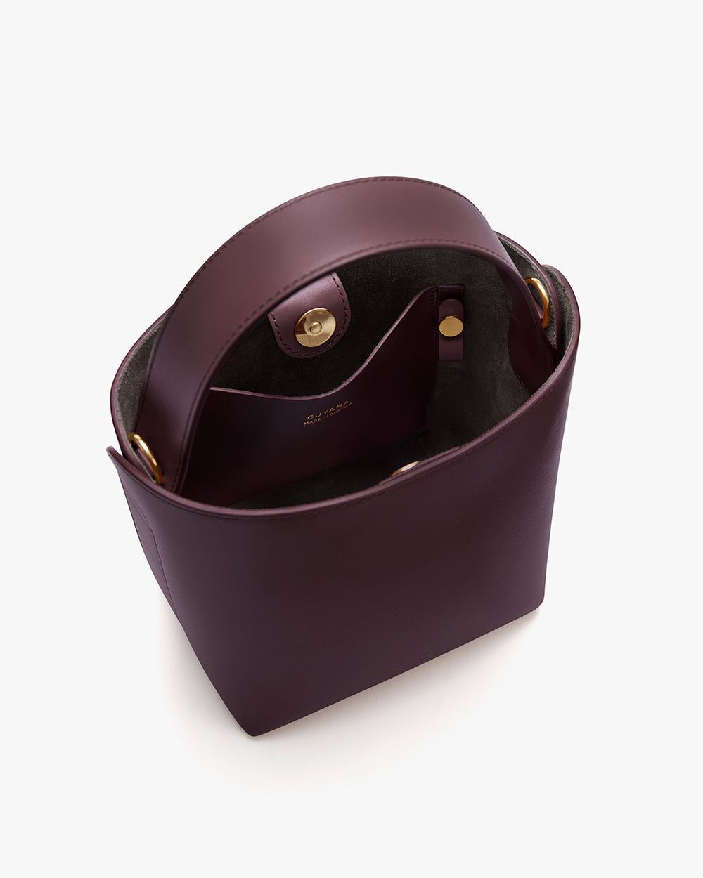 Mini Linea Bucket Bag Open top view of a handbag with a clasp and inner pocket.