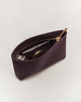 Small open pouch with items including a card and a container