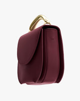 Structured handbag with a curved handle.