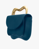 Handbag with unique wavy metal handle and curved flap design.