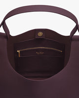 Open handbag with inner zipper pocket and button clasp