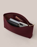 A zippered pouch holding various small items including a wallet and phone.