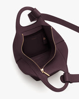 Open leather bag with zipper and inner pocket visible