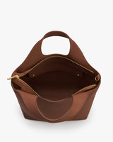 Open handbag showing zippered compartments and handle.