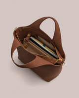 Open handbag with books and items inside