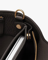 Interior of a bag with metal hardware and a detachable laptop sleeve