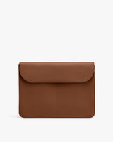 Rectangular leather laptop sleeve with a flap closure.