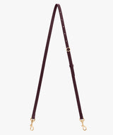 Adjustable bag strap with metal clasps on each end.