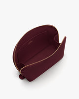 Open pouch with zipper and interior pocket, viewed from above.