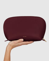 Hand holding a pouch with a zippered top
