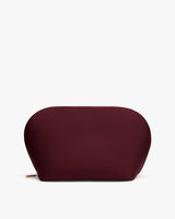 Oval-shaped pouch with a zipper on a flat surface