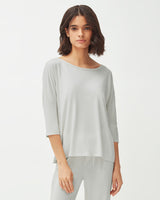 Woman standing in a relaxed pose wearing a casual outfit.