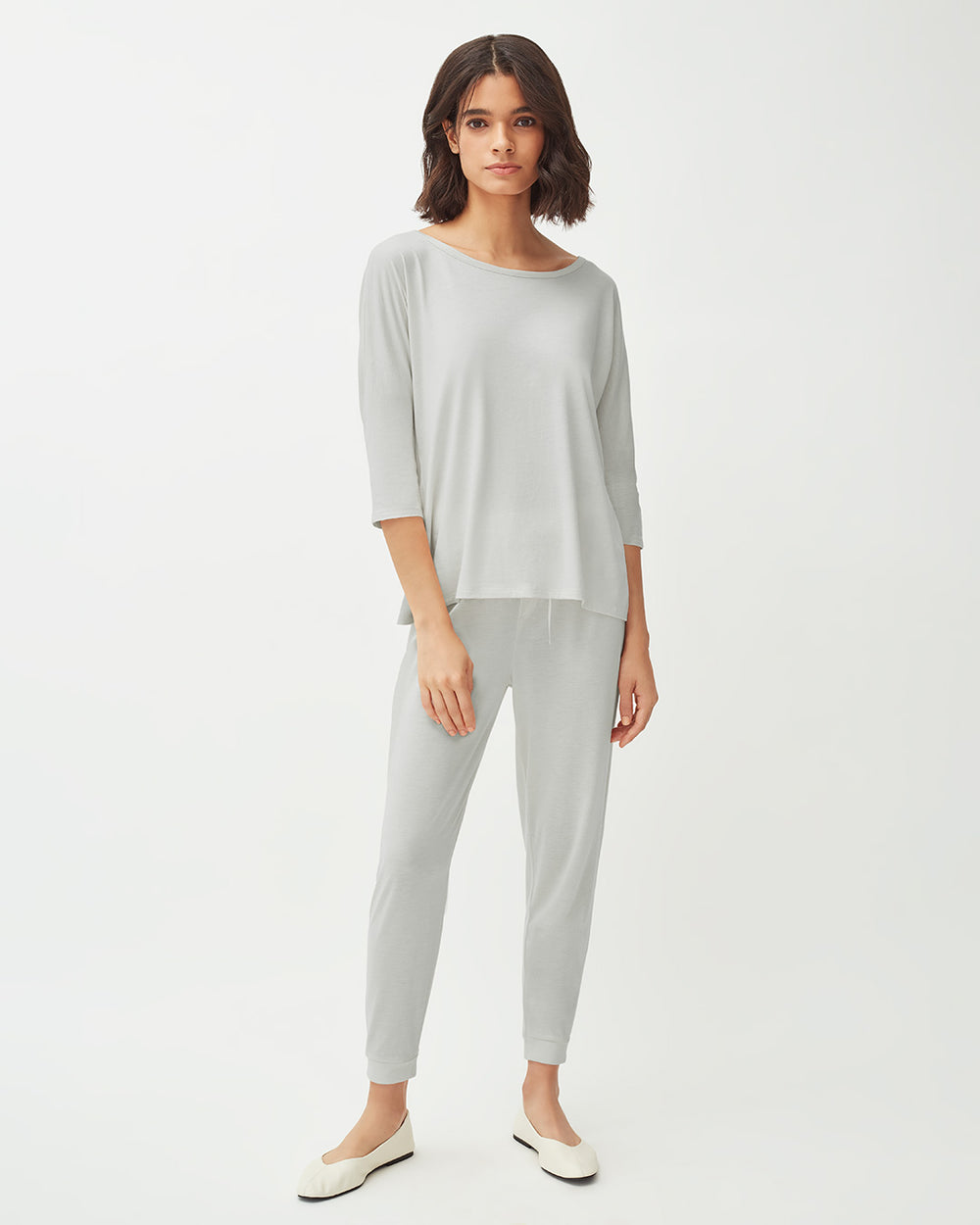 Woman standing in a casual outfit with hands at sides.