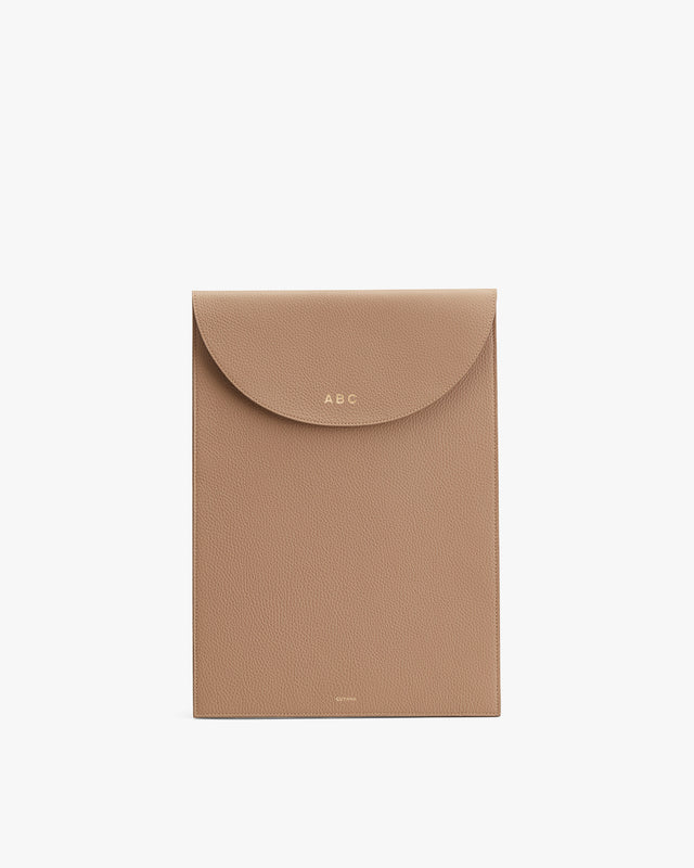 Envelope-style clutch with a flap closure and monogram initials.