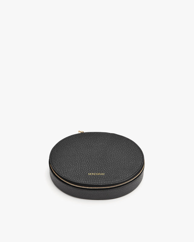 Round zippered case with brand logo on top, isolated on a plain background.