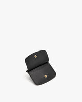 Small purse with snap fasteners, open, on a plain background.