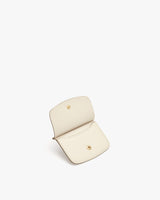 Small open wallet with two snap buttons on white background