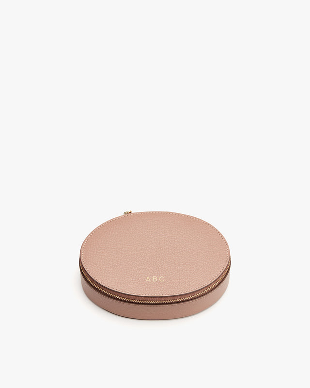 Round zippered case with initials A B C on it.