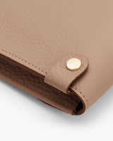 Close-up of a handbag with a metallic clasp.