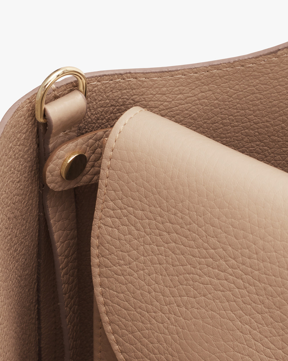 Close-up view of a handbag with visible handle and metal ring.