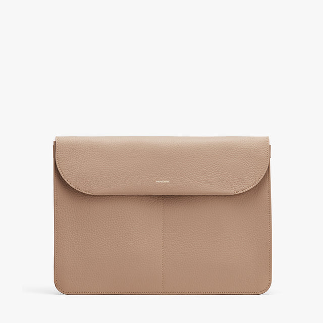 Laptop sleeve with a flap closure on a white background.