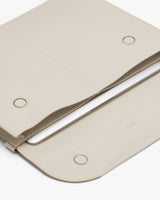 Open laptop sleeve with visible interior and magnetic closure.