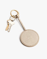 Keychain with a round textured leather tag and two attached keys