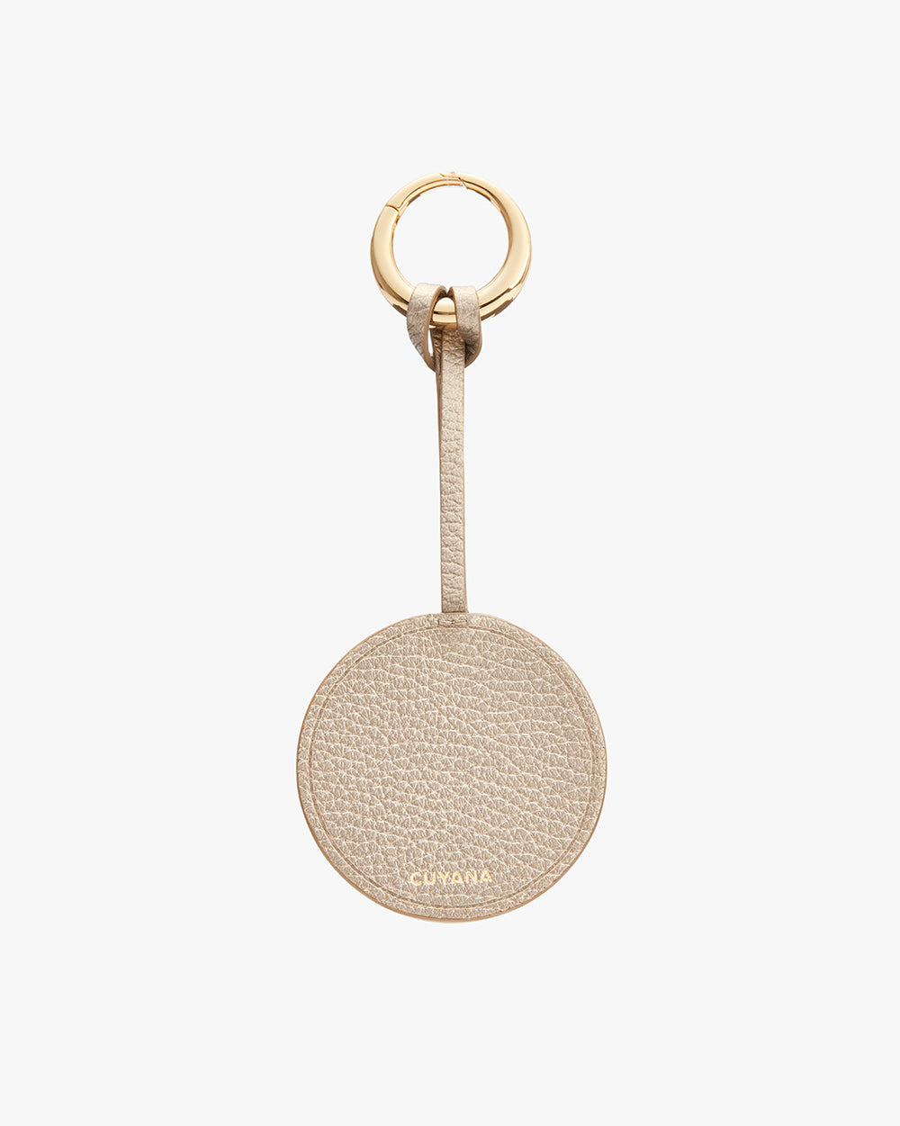 Round keychain with a textured leather finish and a gold-colored ring at the top