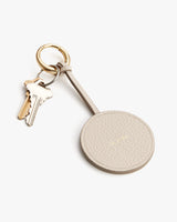 Keychain with attached keys on a white surface.
