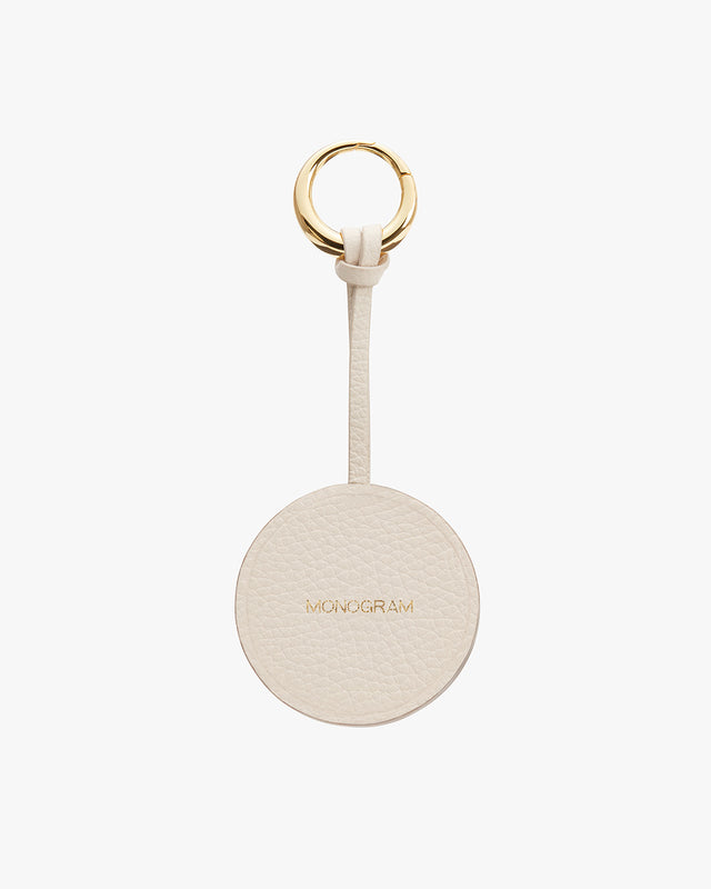 Keyring with a circular tag labeled MONOGRAM and a metal ring attached by a strap.