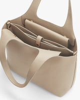 Open handbag showing internal compartments.