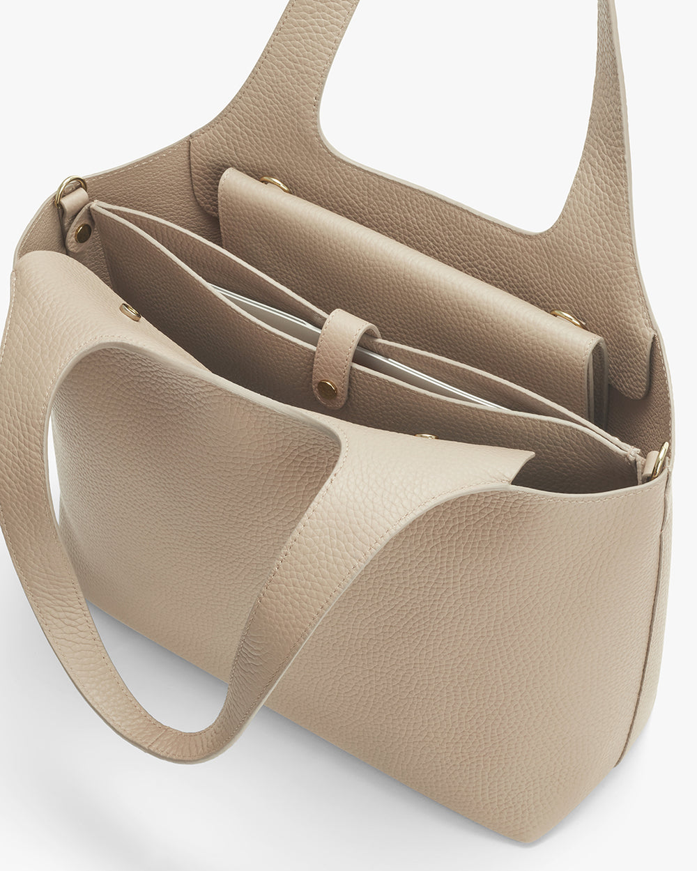 Open handbag showing interior compartments and strap.