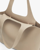 Close-up of a structured tote bag with two handles.