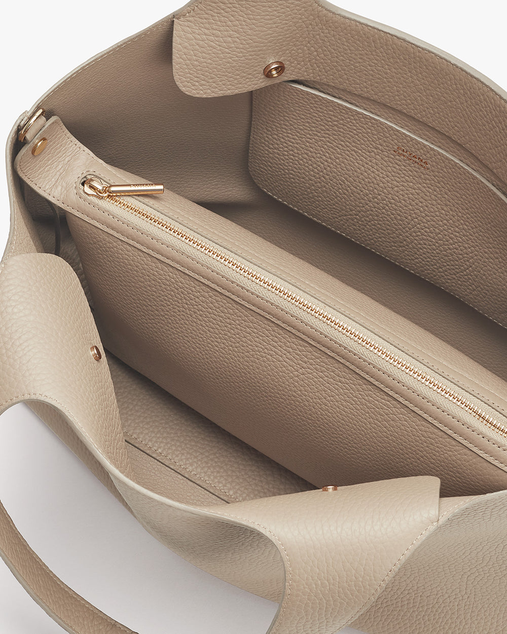 Open handbag showing internal compartments and zipped section.