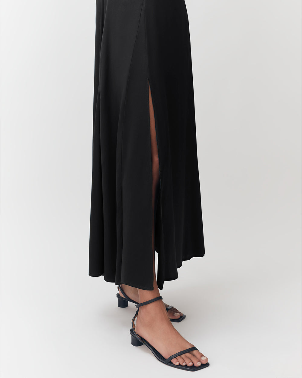 Long skirt with a high slit on one side, worn with strappy sandals.