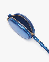 Small oval purse with zipper and attached strap.