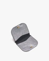 Small wallet open displaying interior with snap fasteners and a fabric band.