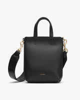Handbag with top handle and detachable shoulder strap.