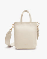 Handbag with top handles and a detachable shoulder strap.