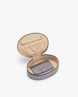 Open jewelry box with a wallet inside.