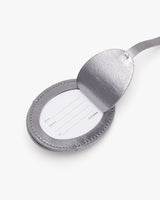 Spoon with a lid containing a paper insert with labeled lines.
