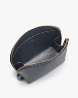 Open leather bag with visible zipper and internal compartments.