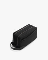 Rectangular toiletry bag with two zippers, handle on one end, and a side pocket.