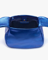 Open handbag on plain background