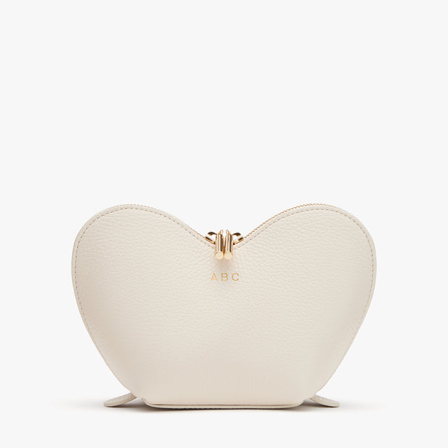 Heart-shaped purse with initials 'A.B.C' and a zipper.