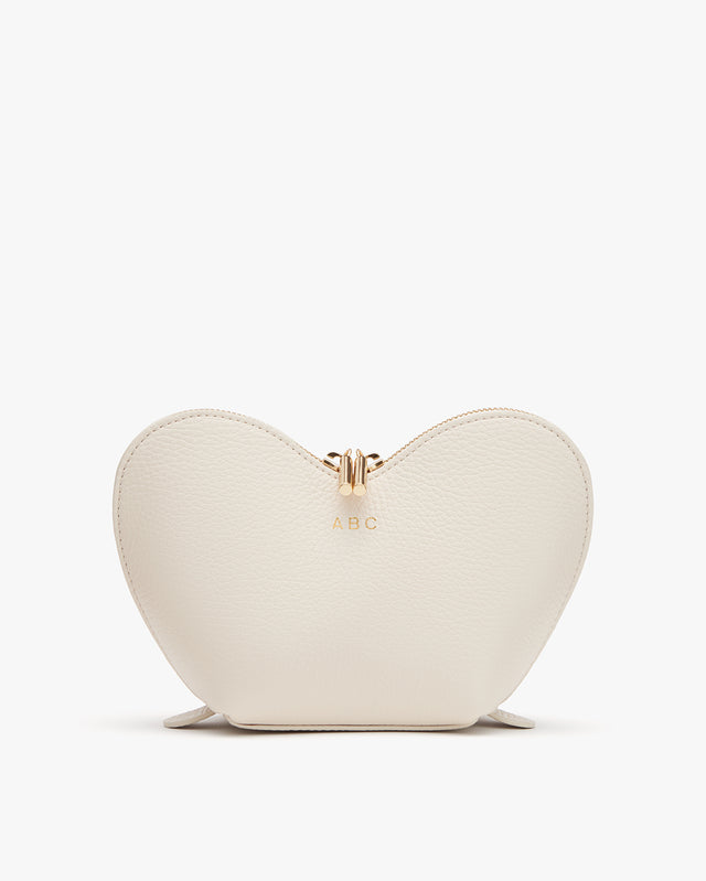Heart-shaped purse with initials 'A.B.C' and a zipper.