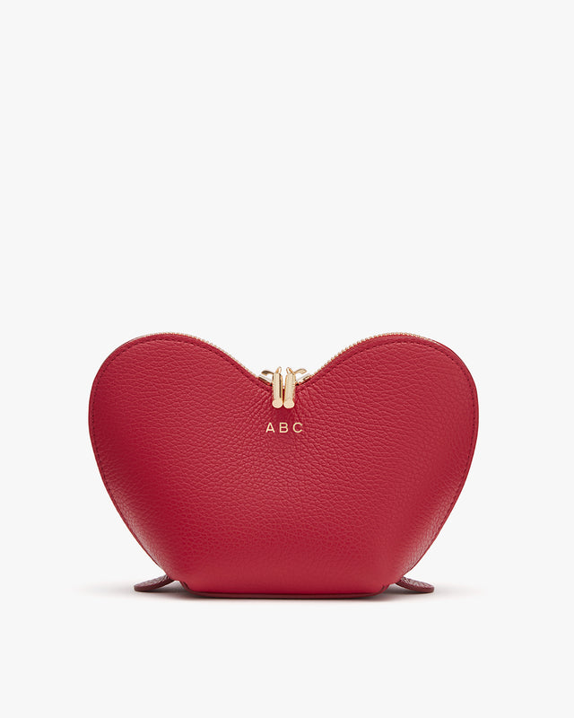 Heart-shaped purse with a monogram and zipper closure