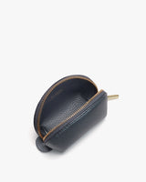 Small zippered pouch standing upright on a plain surface