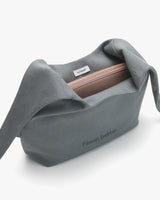 Open shoulder bag with a zipper and branded text.